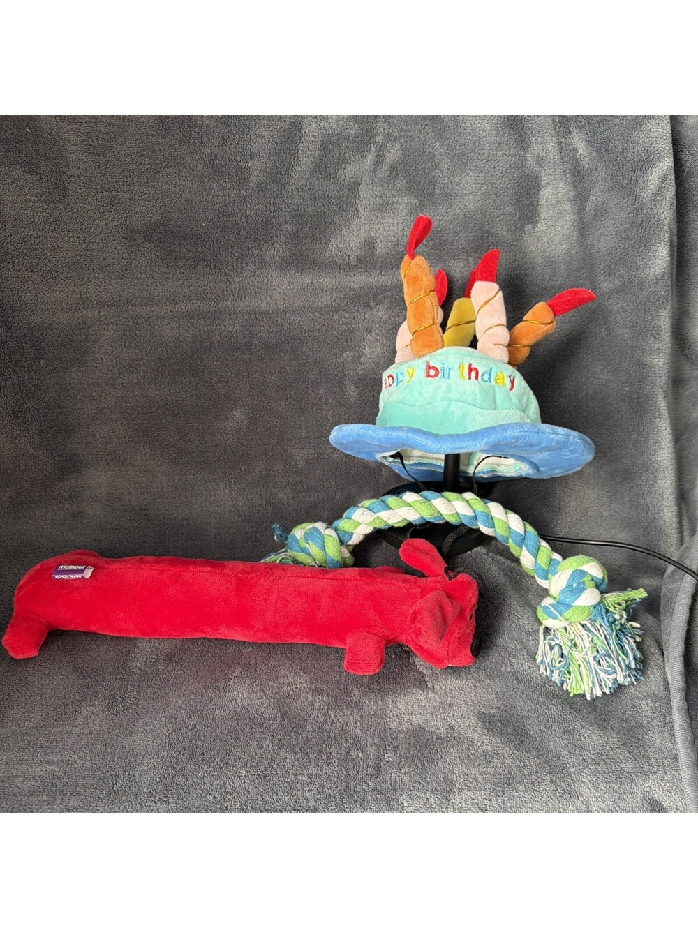 Assorted Dog Toys And Happy Birthday Hat